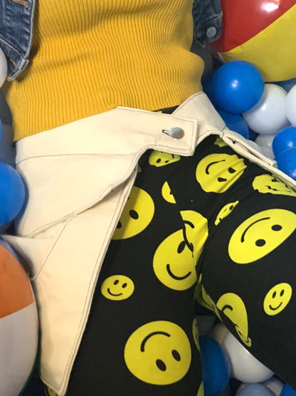 a close-up of someone wearing a pair of off-white pockets while laying in a ball pit.