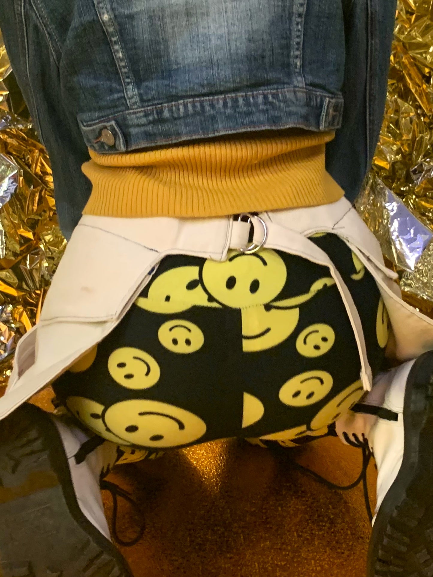 A close-up of someone wearing a pair of off-white pockets, highlighting the adjustable strap.